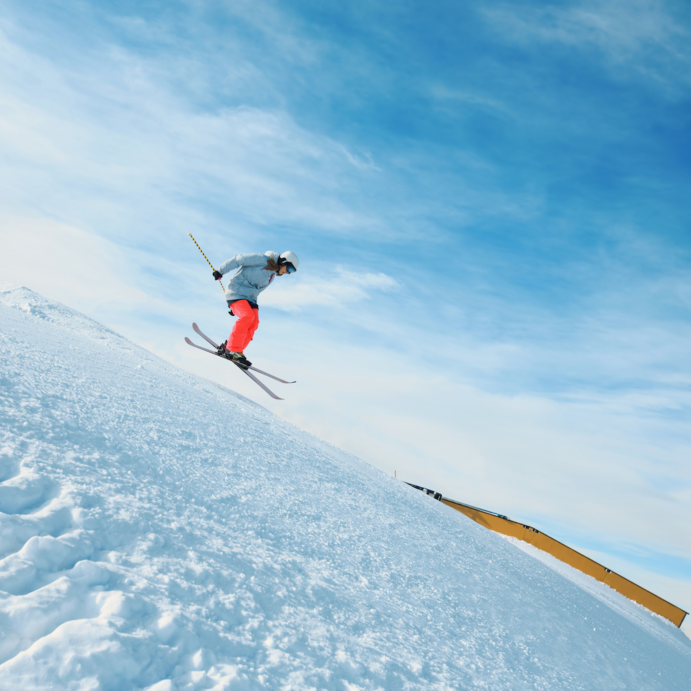 Young women Freestyle skier in a jump