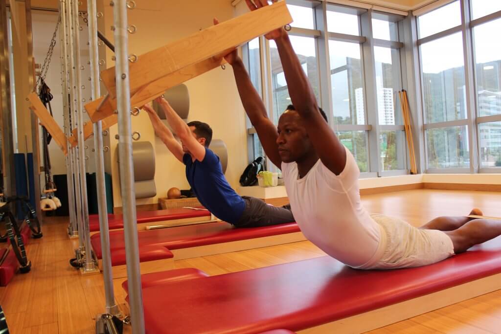 Pilates trainer exercises on a pilates barrel. Body training